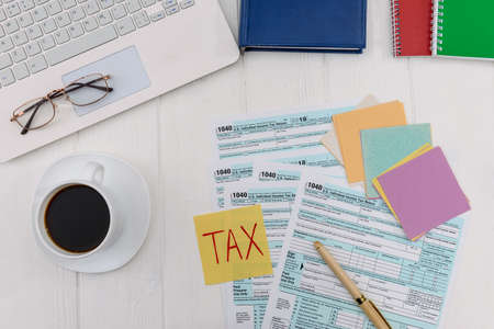 Coffee cup with 1040 form and colorful stickersの写真素材