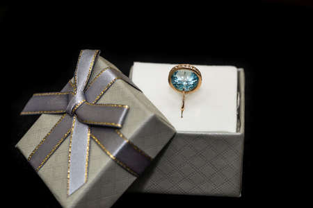 Silver gift box with ring isolated on black