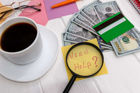 Coffee with credit card, dollars and 'need help' text