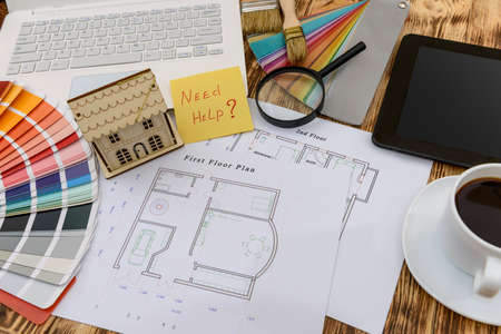 Top view at house plan and laptop with color samplerの写真素材