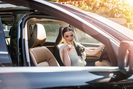 Woman with keys inside car on driver seat