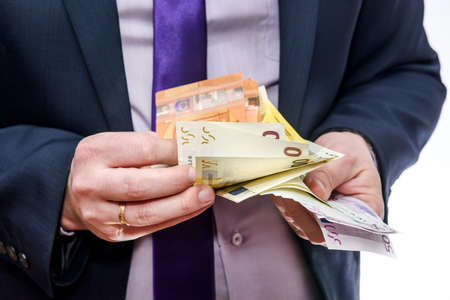 Man in suit counting euro banknotes isolated on white