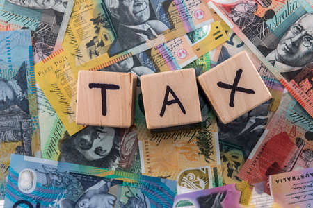 Wooden cubes with word 'Tax' on australian dollarsの写真素材