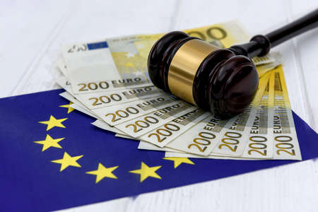Euro banknotes with judge's gavel and european union flag