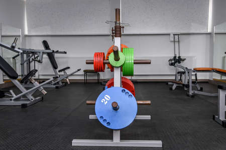 Different color weights for barbells in gymの写真素材