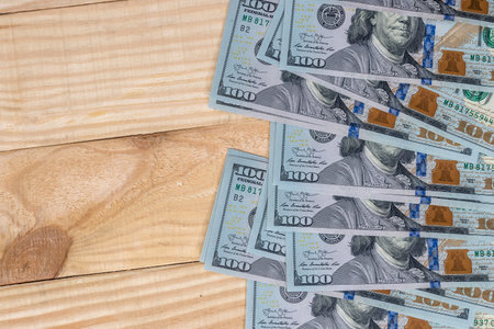 100 dollar banknote on wooden deskの写真素材