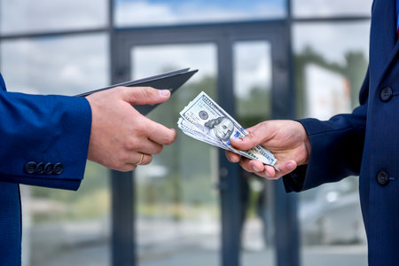 Male hands with dollar banknotes outdoors close upの写真素材