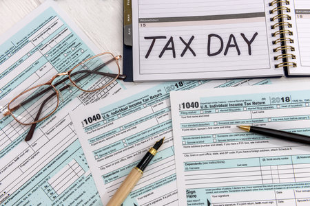 1040 form with notepad, tax day conceptの写真素材