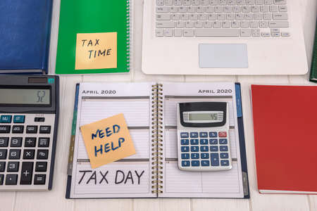 Workplace with laptop, calculator, diary, tax dayの写真素材
