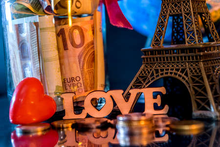 Wooden plank love with savings for traveling and eiffel towerの写真素材