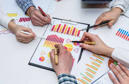 Group of people working with business graph in office