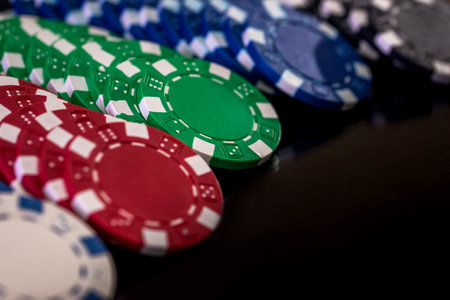 Selective focus on colorful casino chips on dark backgroundの写真素材