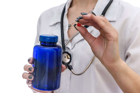 Colorful pills in female hands isolated on whiteの写真素材