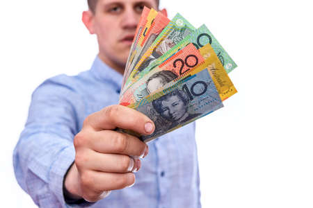 Man holding australian dollar banknotes isolated on whiteの写真素材