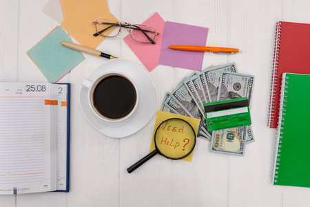 Dollars with credit card and magnifier on laptop keyboardのeditorial素材