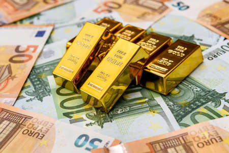 Euro banknotes and gold ingots close upの写真素材