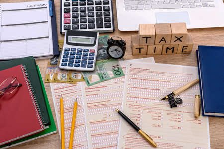 Australian dollars with individual tax form on the deskの写真素材