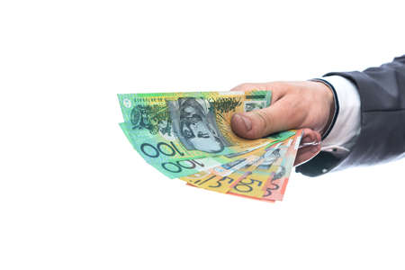 Australian dollars in male hand isolated on whiteの写真素材