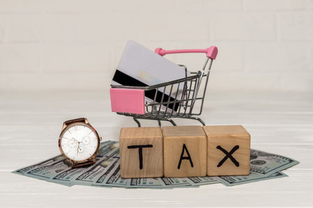 Wooden cubes with dollar banknotes and wrist watchの写真素材