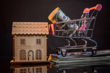 Dollar roll in toy cart at dark backgroundの写真素材