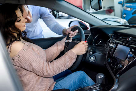 Sales manager explaining details to customer in showroomの写真素材