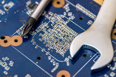 Steel spanners on motherboard of pc close up