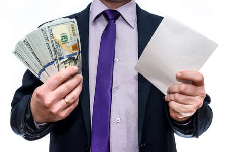 Businessman holding dollar banknotes and envelope in hands