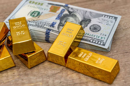 Gold bullion on american dollar banknotes close upの写真素材