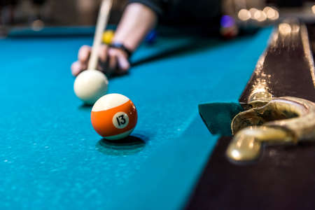 Hand with cue going hit a ball