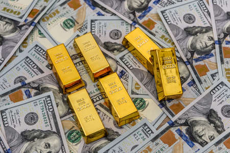 Bullion of gold in row on dollars backgroundの写真素材