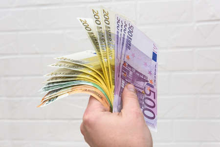 Human hand with euro banknotes close up