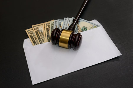 American dollars in envelope with judge's gavel on darkの写真素材