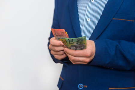 Male hands counting australian dollar banknotes, macroの写真素材