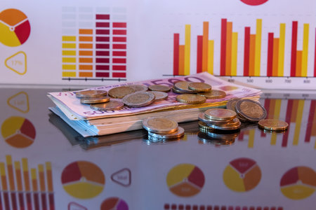 Stack of paper euro and coins with reflectionの写真素材