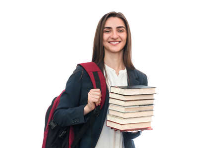 Young girl with books and bag isolated on whiteの写真素材