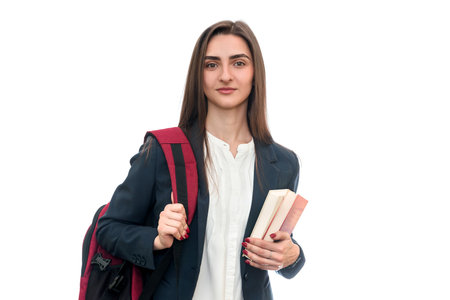 Young girl with books and bag isolated on whiteの写真素材