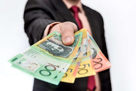 Man holding australian dollar banknotes close upの写真素材