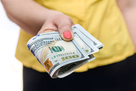 Female hands holding pile of dollar banknotes close upの写真素材