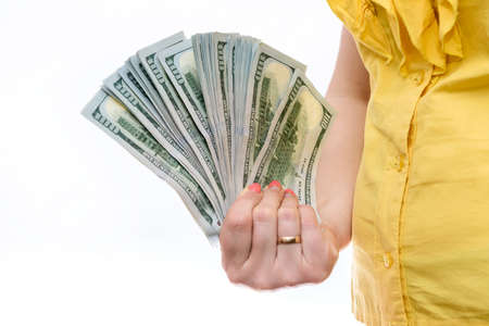 Female hand offering dollar banknotes in fan