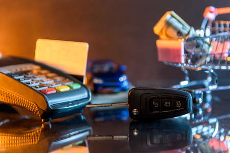 Terminal with card and toy car with dollar and cartの写真素材