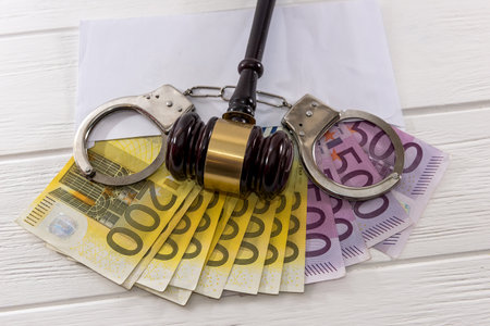 Euro banknotes with judge's gavel and handcuffsの写真素材