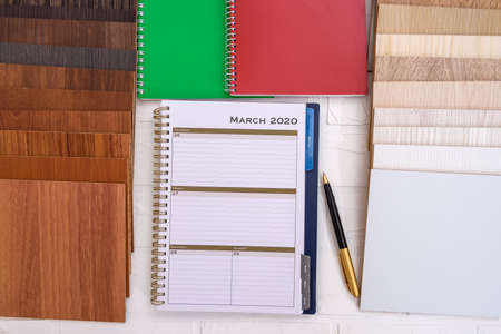 Samples of wooden planks with diary and pen