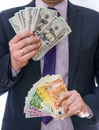 Male hands holding dollar and euro banknotes in fanの写真素材
