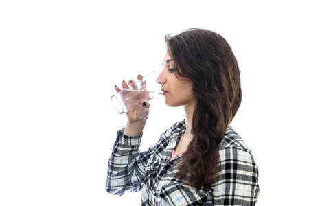 Woman drinking water from glass isolated on white