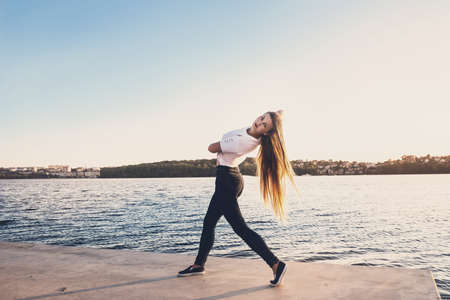 Young beautiful woman walking in park with lakeの写真素材