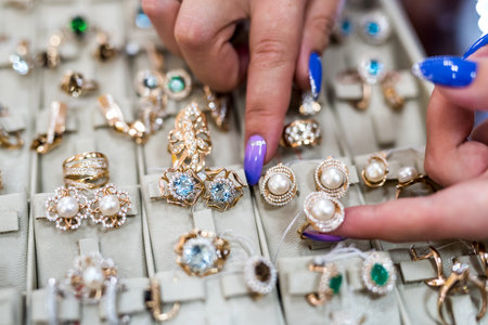 Female hands with golden jewelery in shop close upの写真素材