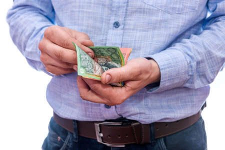 Man holding australian dollar banknotes isolated on whiteの写真素材