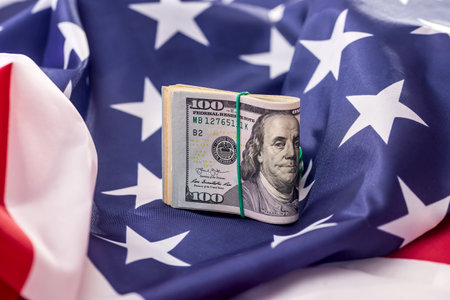 American dollars in bunch on national flag