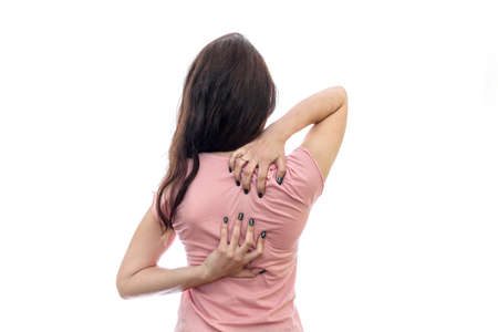 Female back with hands on neck isolated on whiteの写真素材