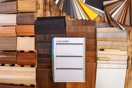 Notepad with wooden sampler on the table